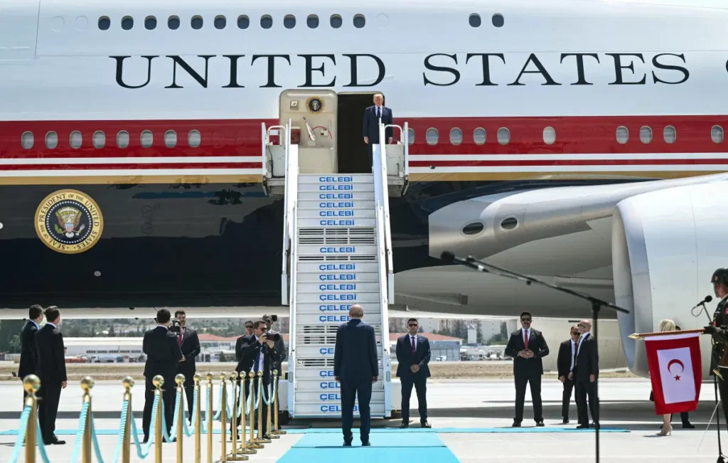 Turkish President Recep Tayyip Erdogan (C, bottom) welcomes US President Donald Trump (up) upon his arrival on Air Force One at Etimesgut Air Base near Ankara, on July 7, 2026, as he travels to attend the 36th NATO Heads of State and Government Summit. (Photo by SAUL LOEB / AFP)